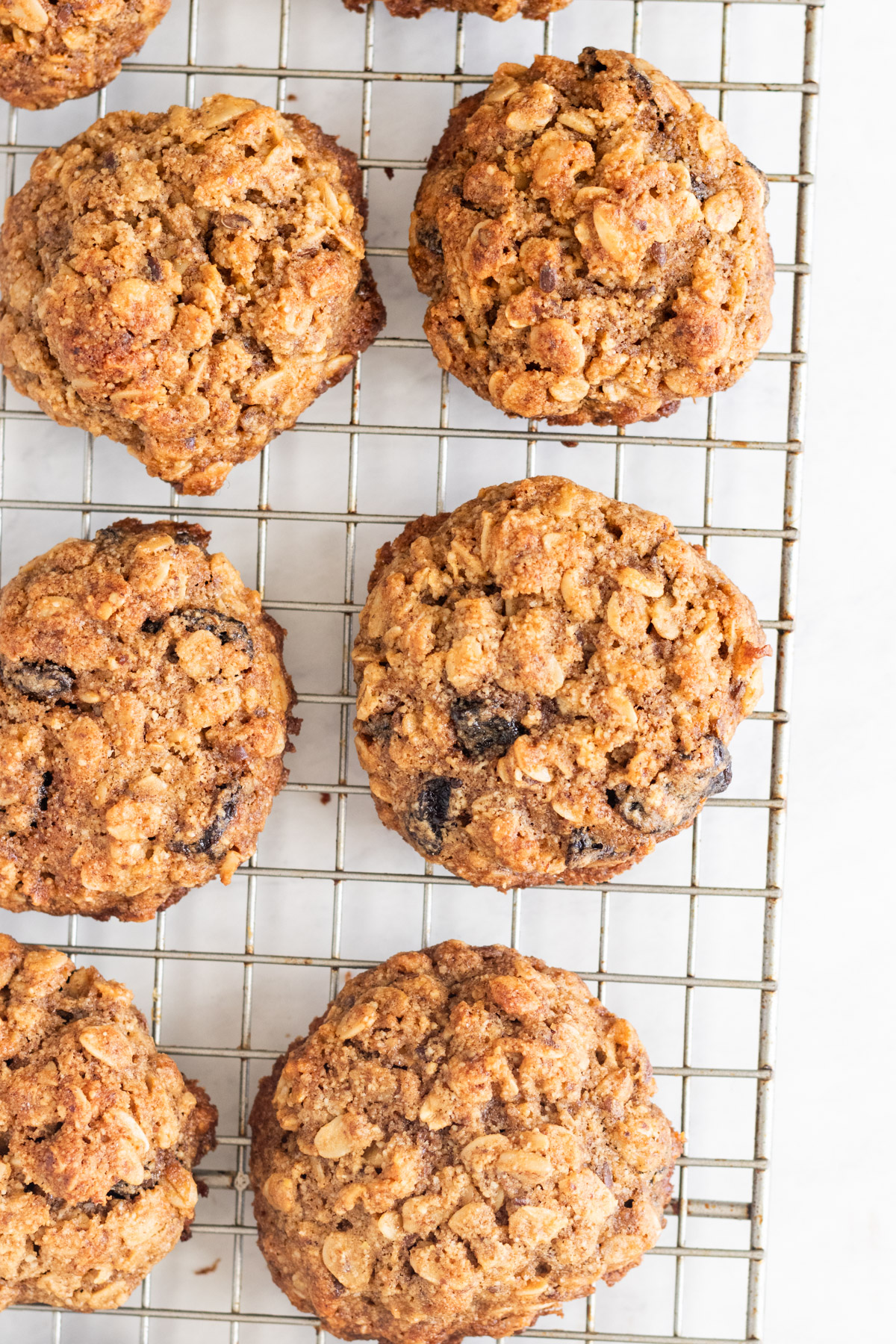 Gluten free oatmeal raisin cookies on a wire rack.
