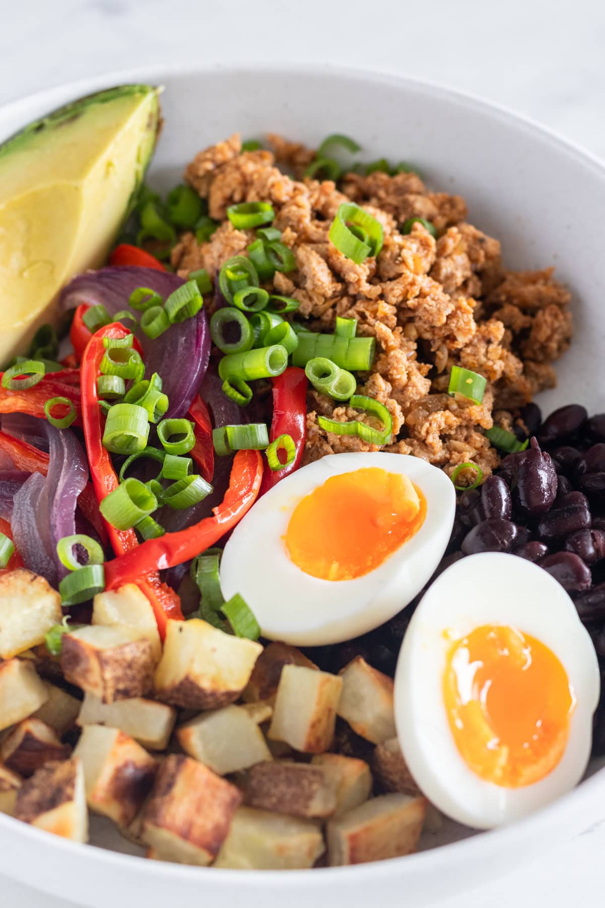 Breakfast bowl with avocado and potatoes.