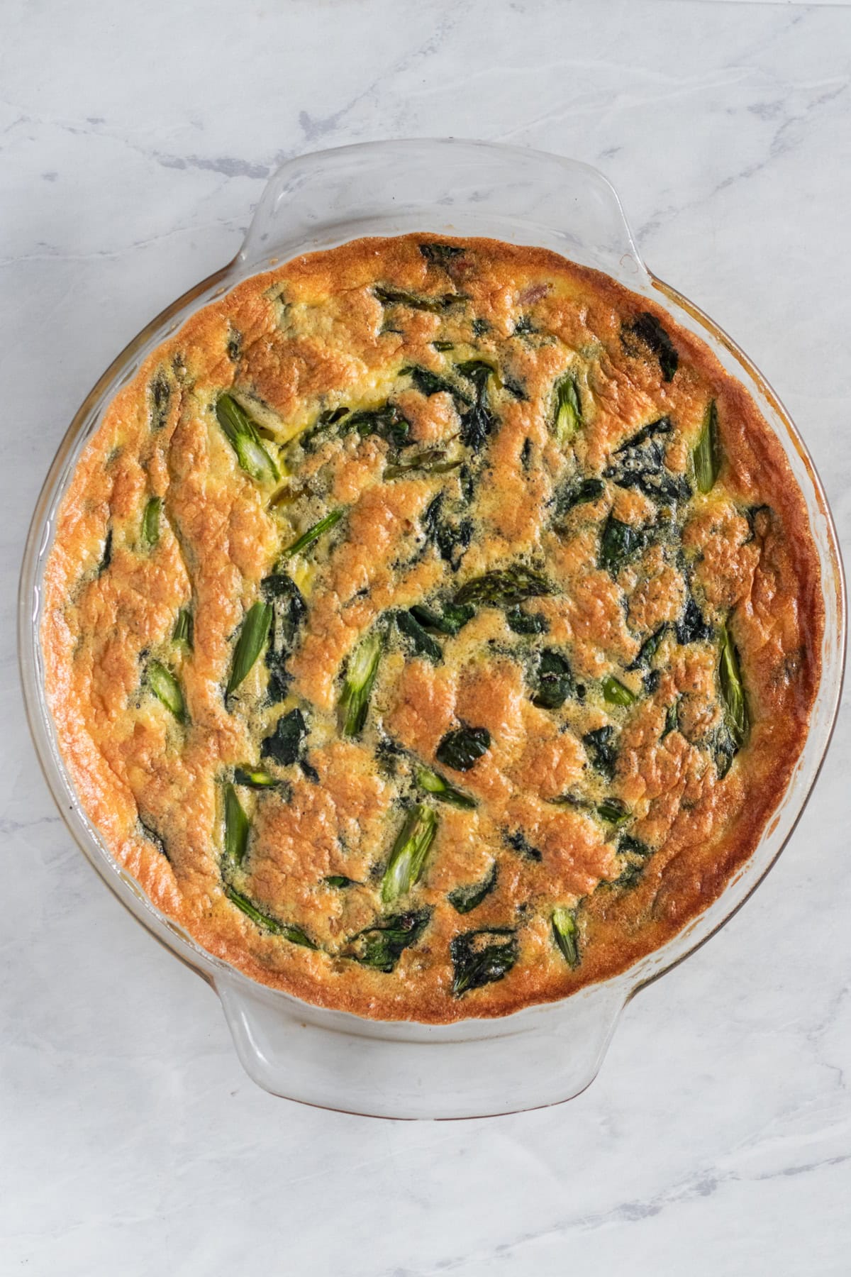 Crustless asparagus quiche in a pie dish.