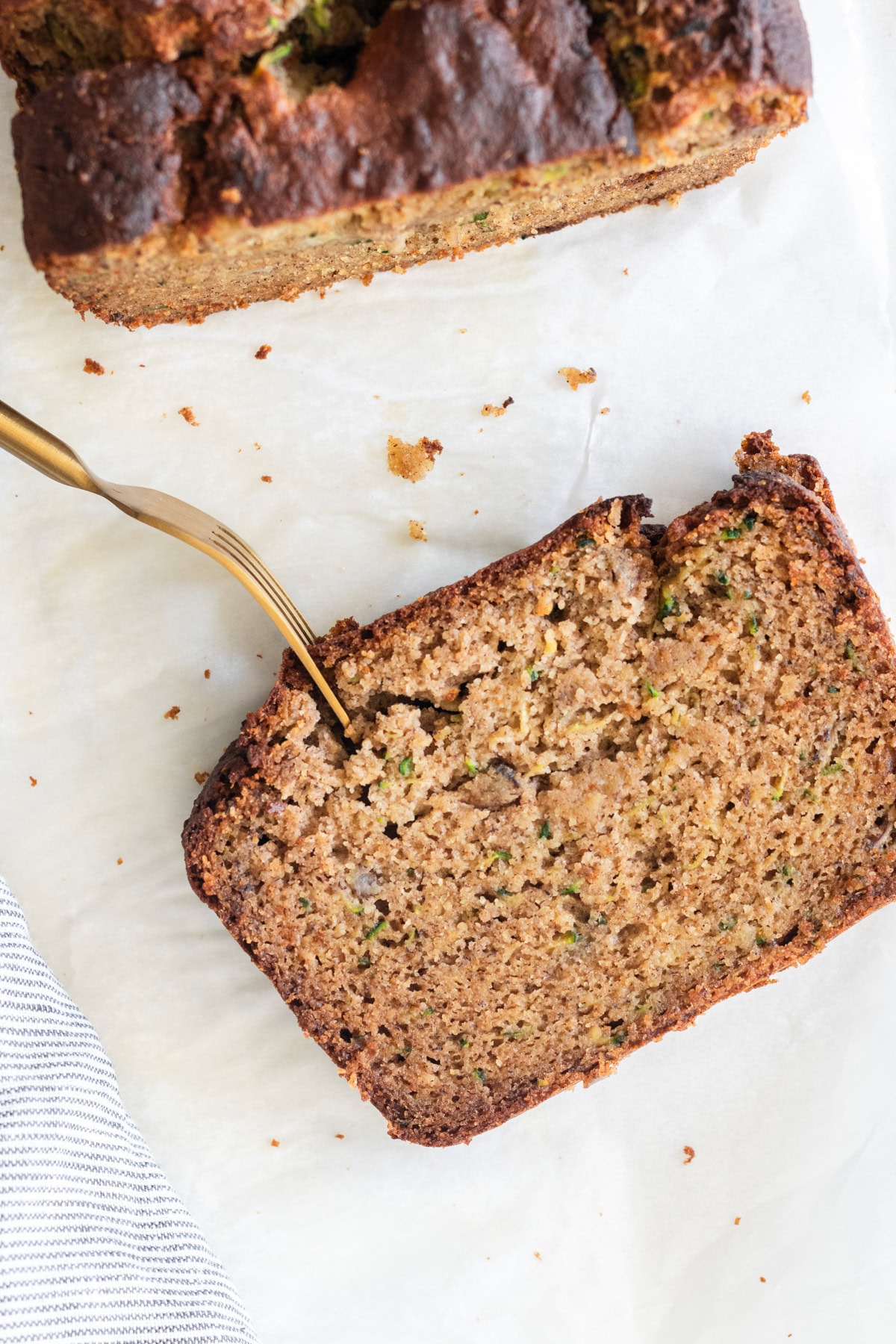 Fork in a slice of gluten-free zucchini banana bread.