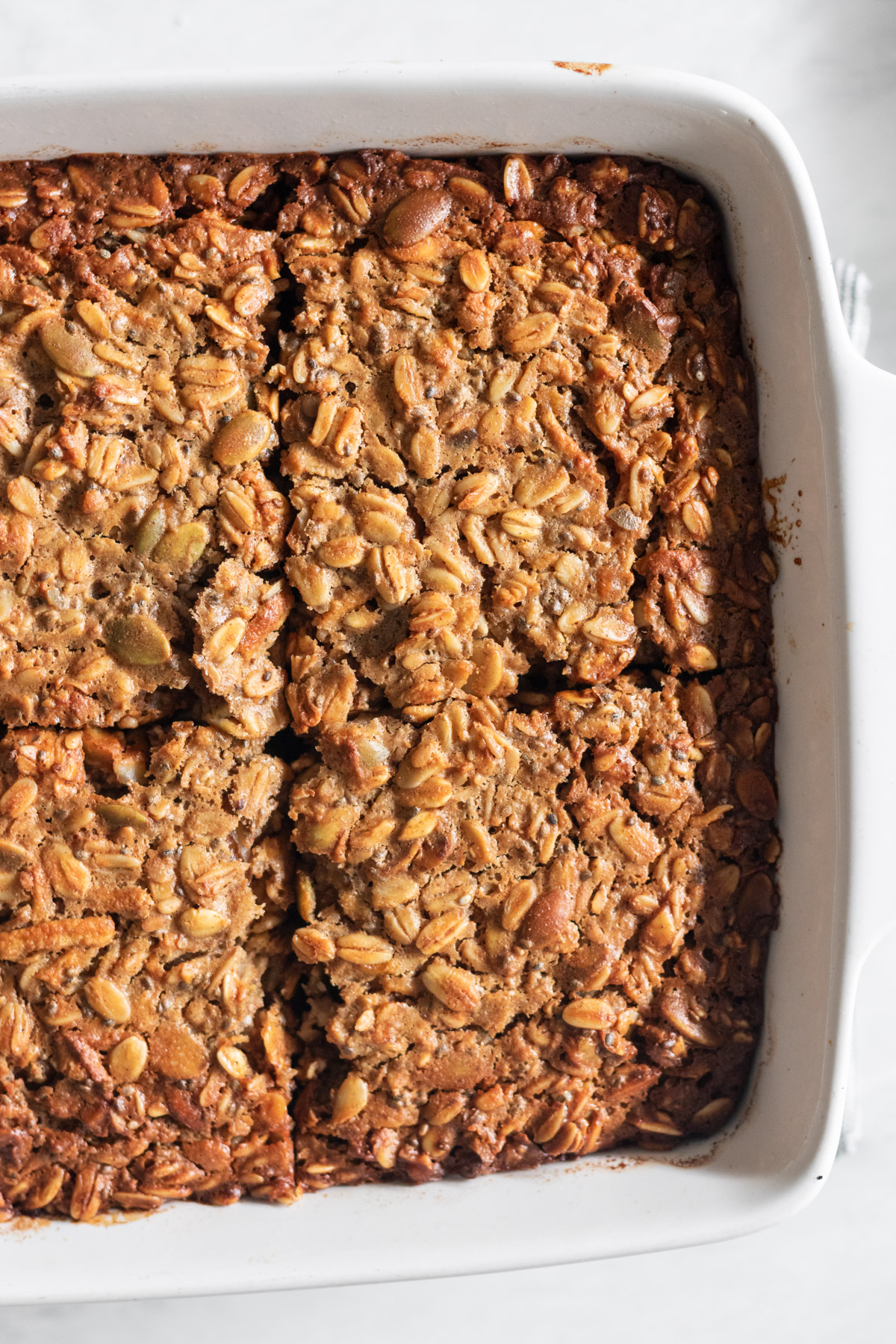 Sliced baked oats in a white dish.