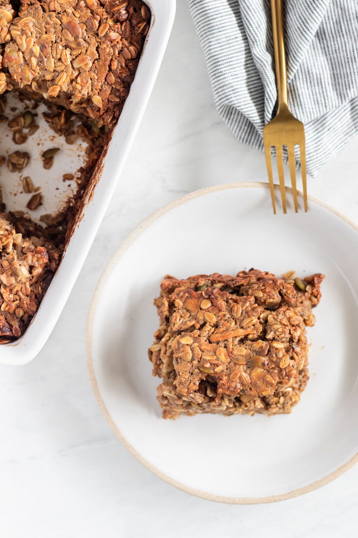Slice of baked oatmeal on a white plate.